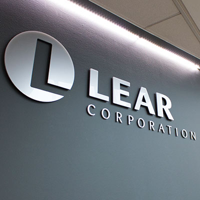 Tamlite Lear Corporation logo